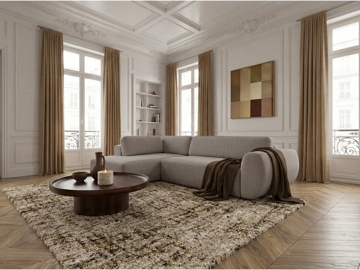 Helles Bobochic Ecksofa Denise mit Kissen und Decke im Wohnraum